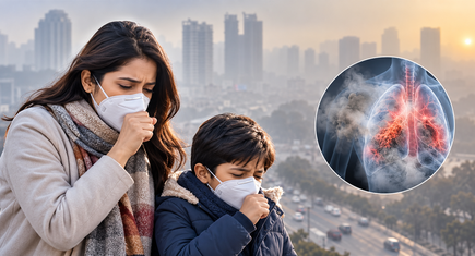 A man wearing an N95 mask holding his chest and coughing amidst severe winter smog and air pollution near India Gate in Delhi NCR.